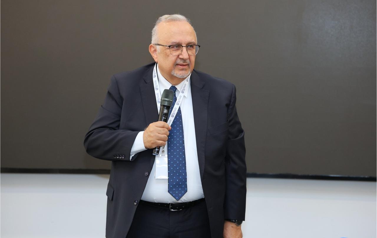 Professor Badran A. Badran speaking to an audience, microphone in hand